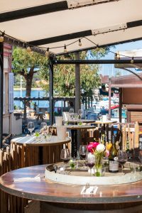 Photo - Destination Les Medes 249mp Outside tables during the day with glasses of wine - hotel les medes porquerolles